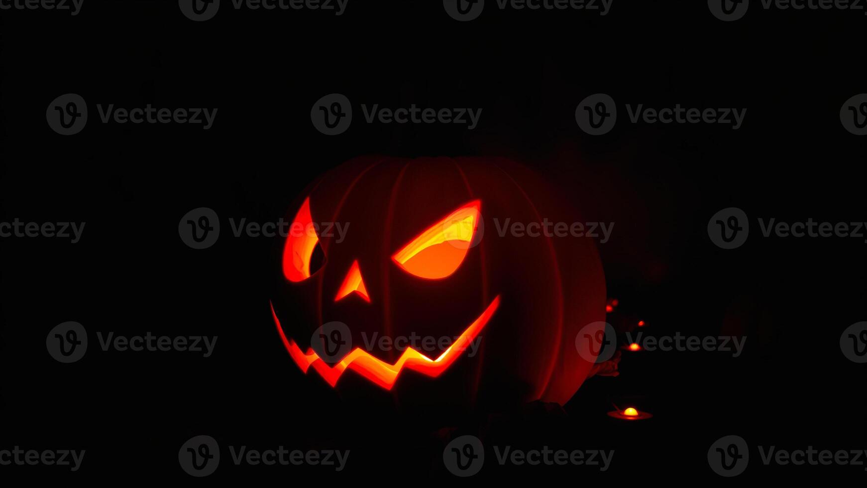 glowing carved pumpkin with a sinister smile photo