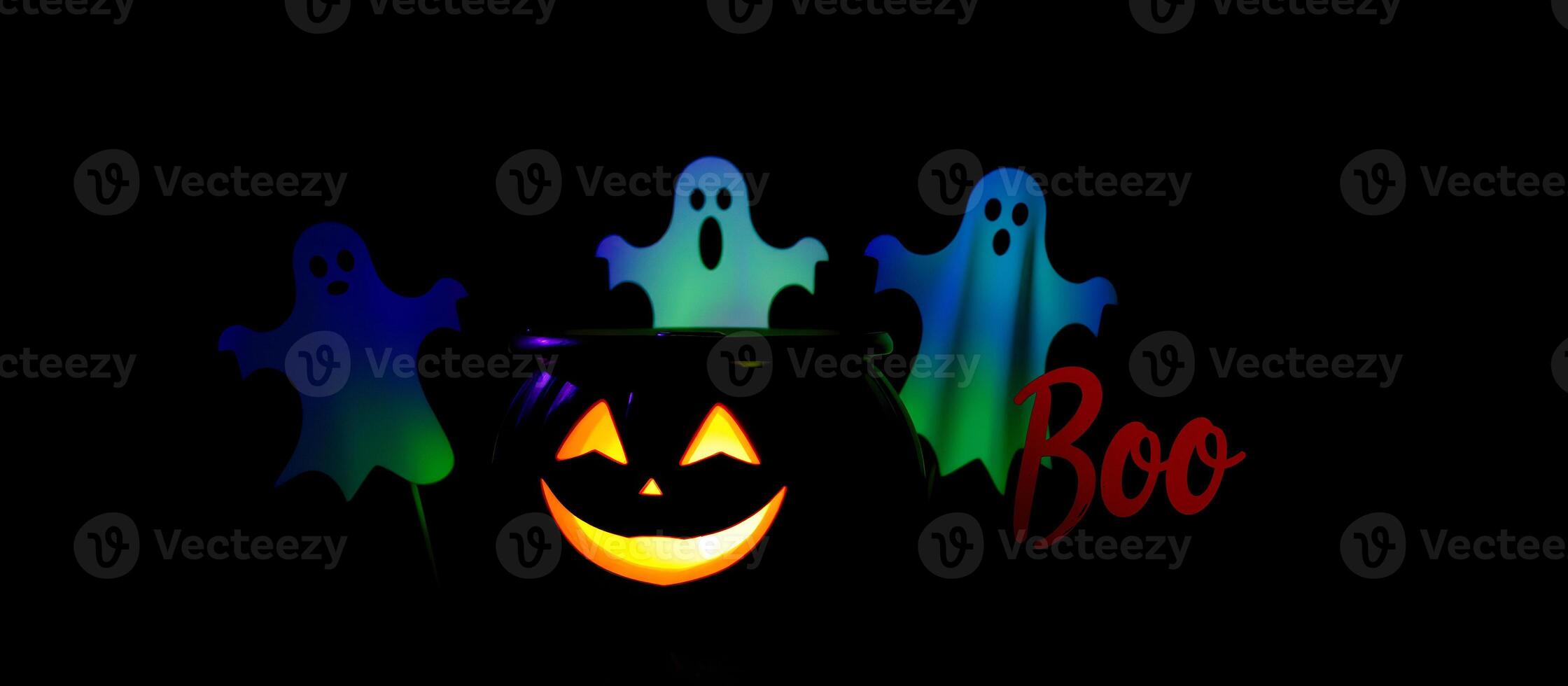 glowing jack-o'-lantern with three ghosts photo