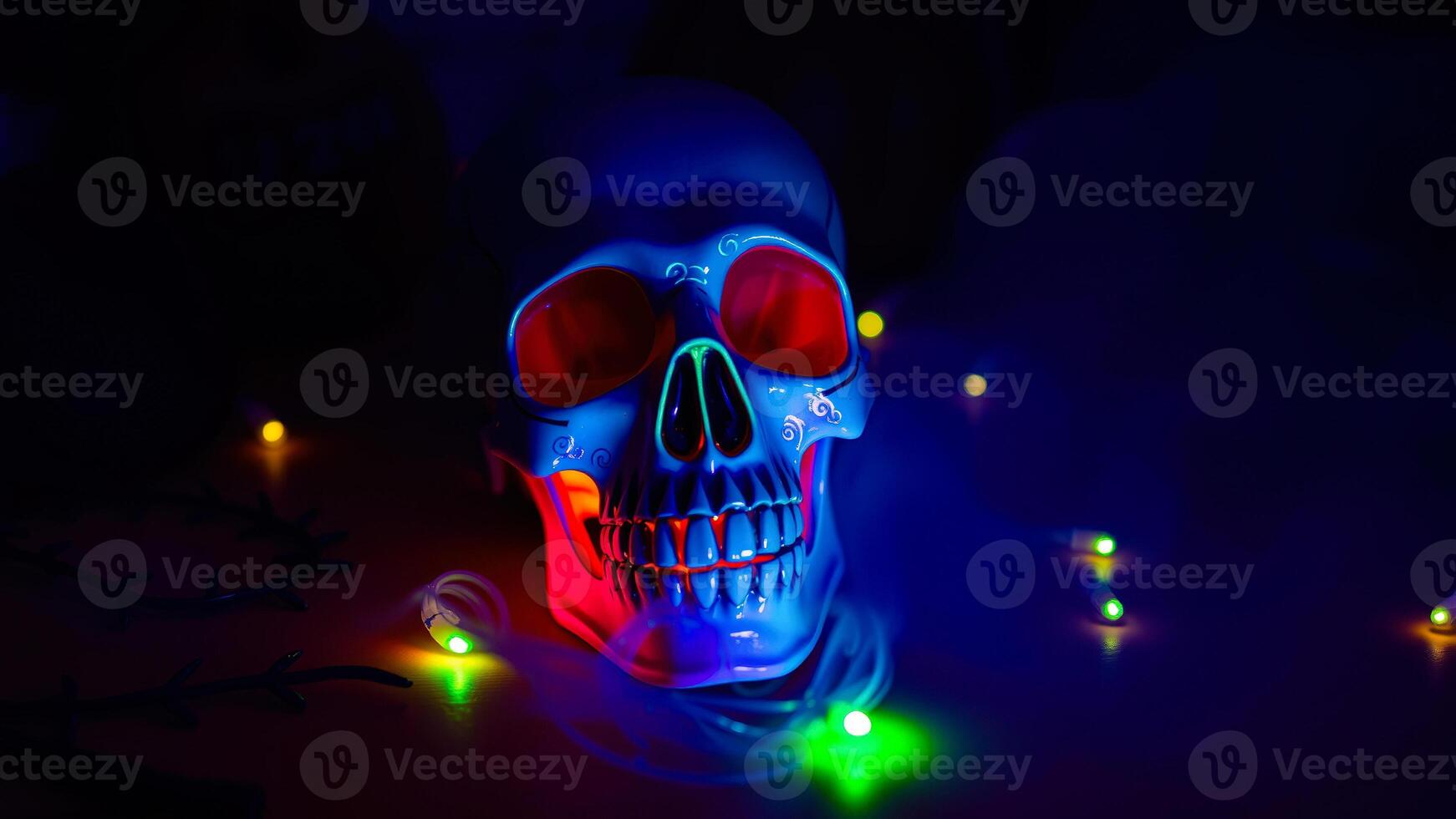 blue ceramic skull illuminated with colorful lights photo