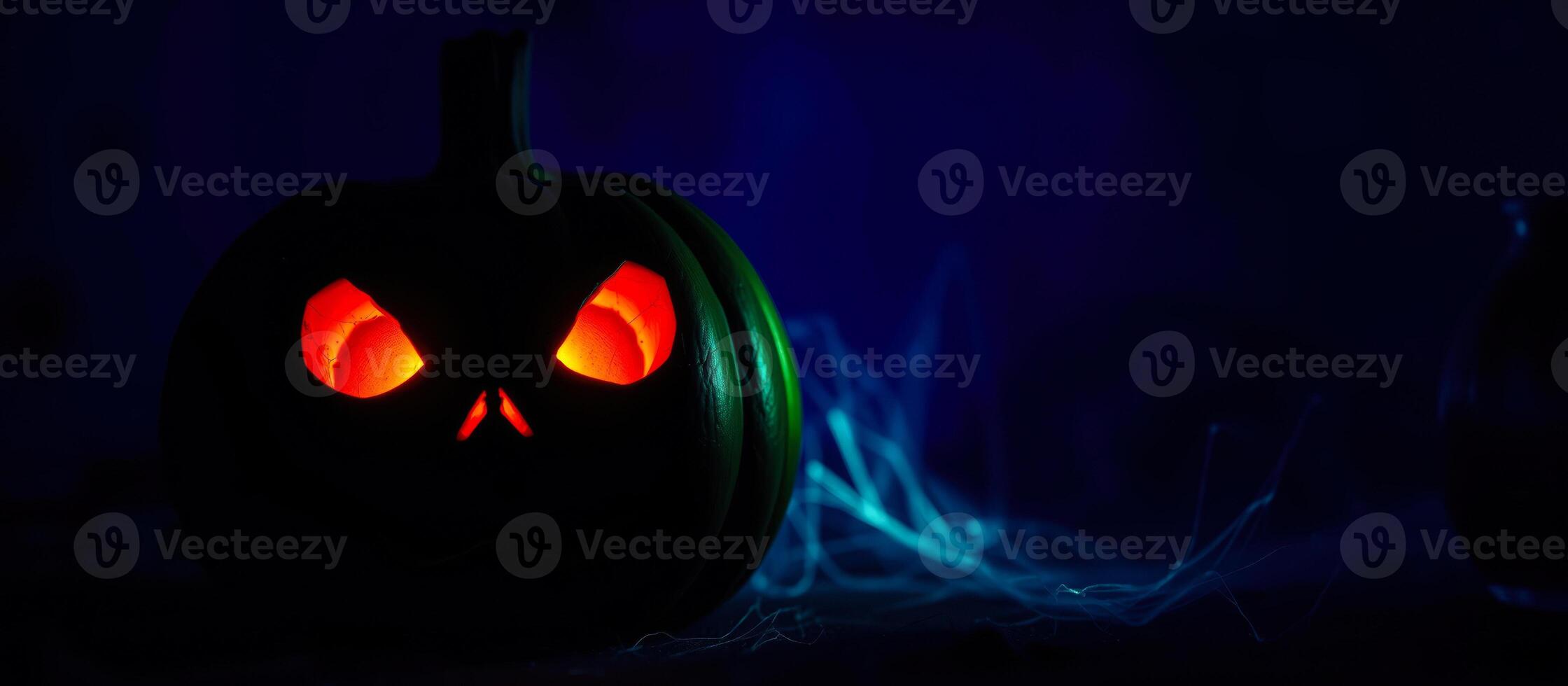 glowing pumpkin with eerie blue smoke photo