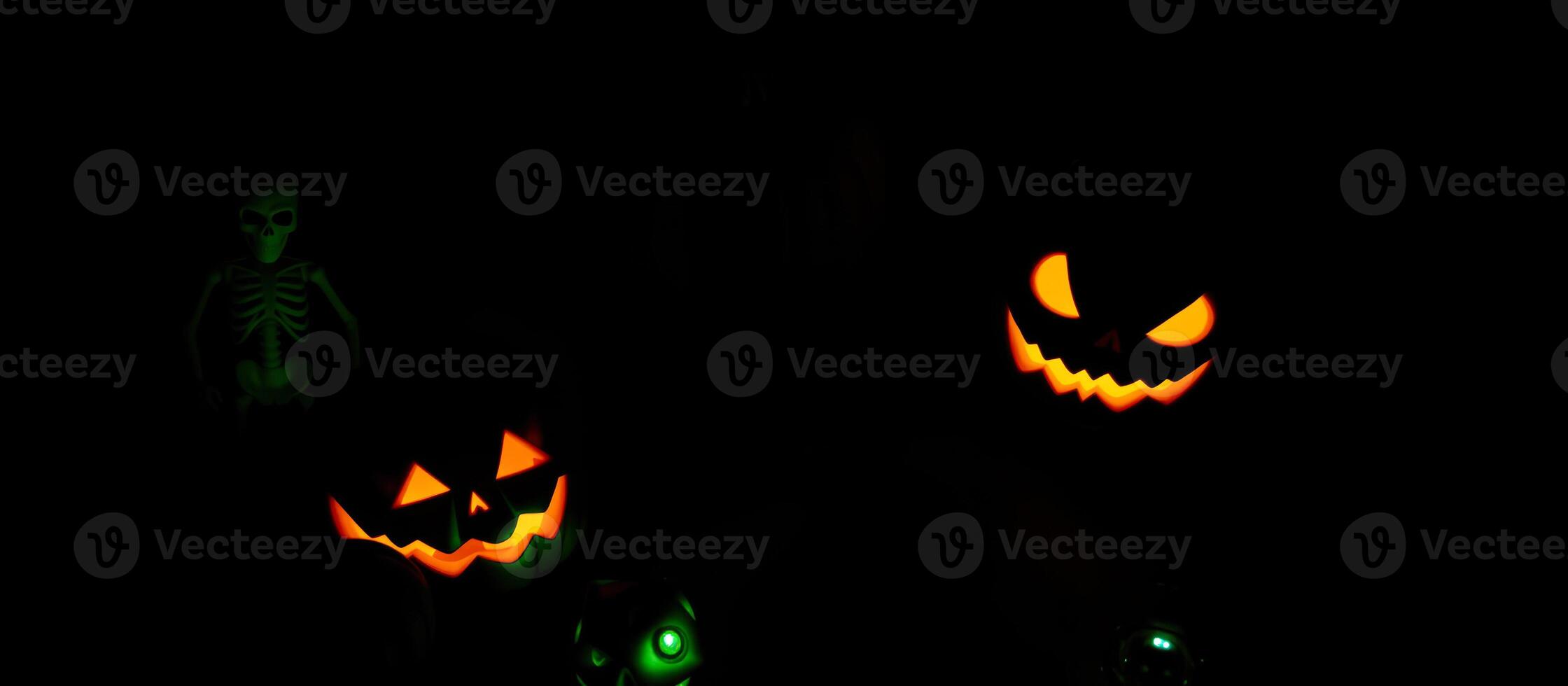 illuminated jack-o'-lanterns a skeleton cast a spooky glow photo