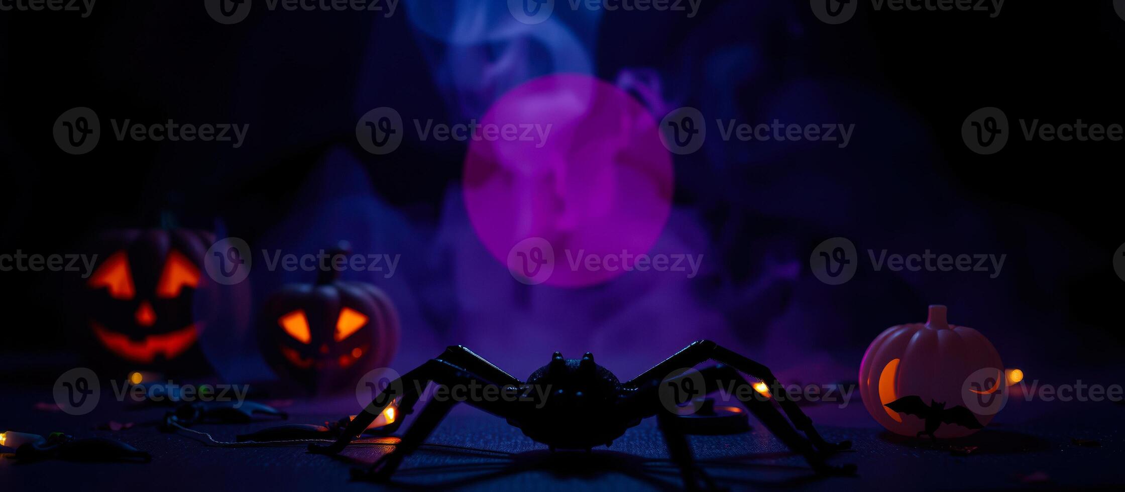 black spider poses before glowing pumpkins photo