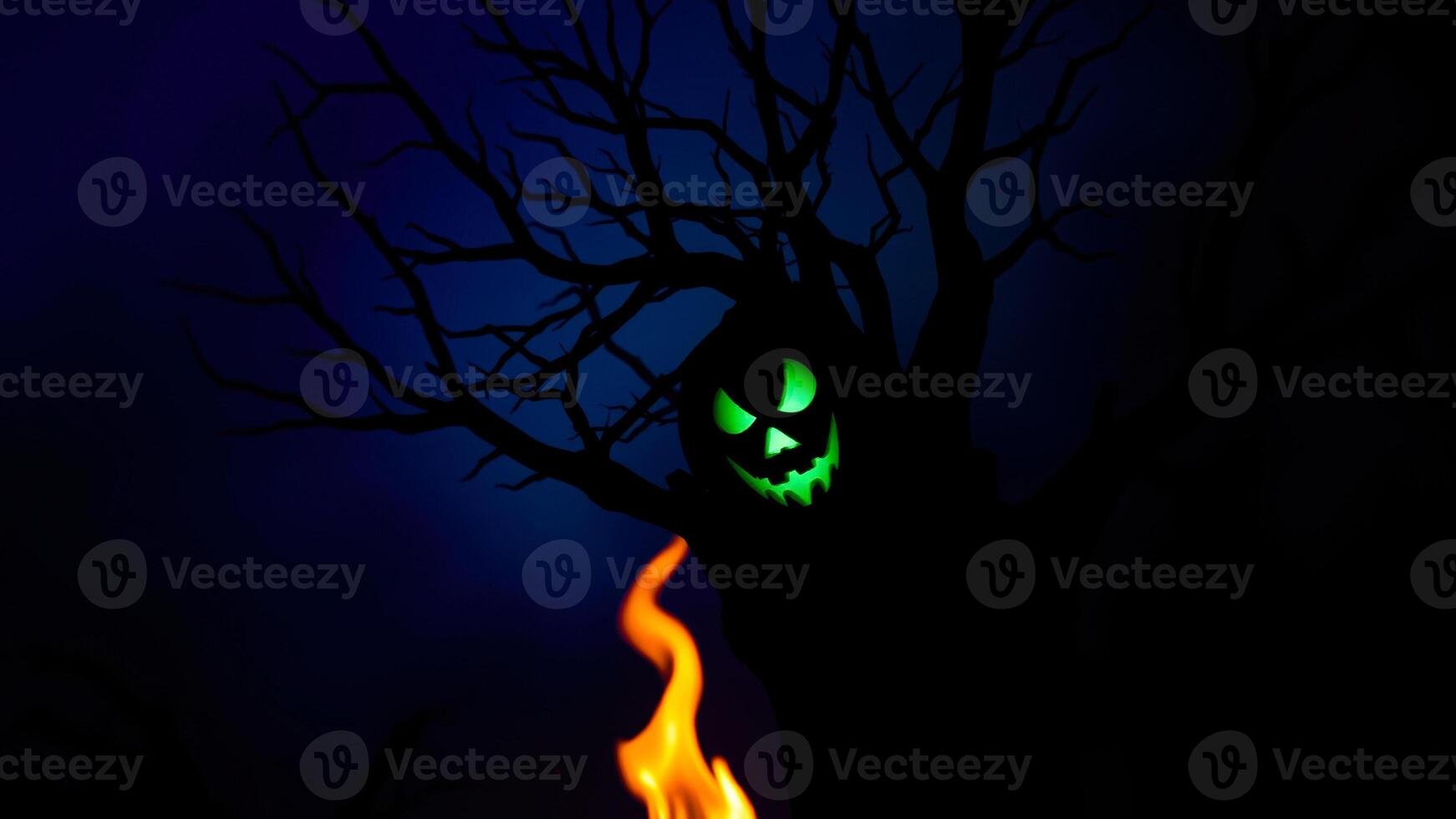 glowing jack-o'-lantern face peeks out from behind a shadowy tree photo