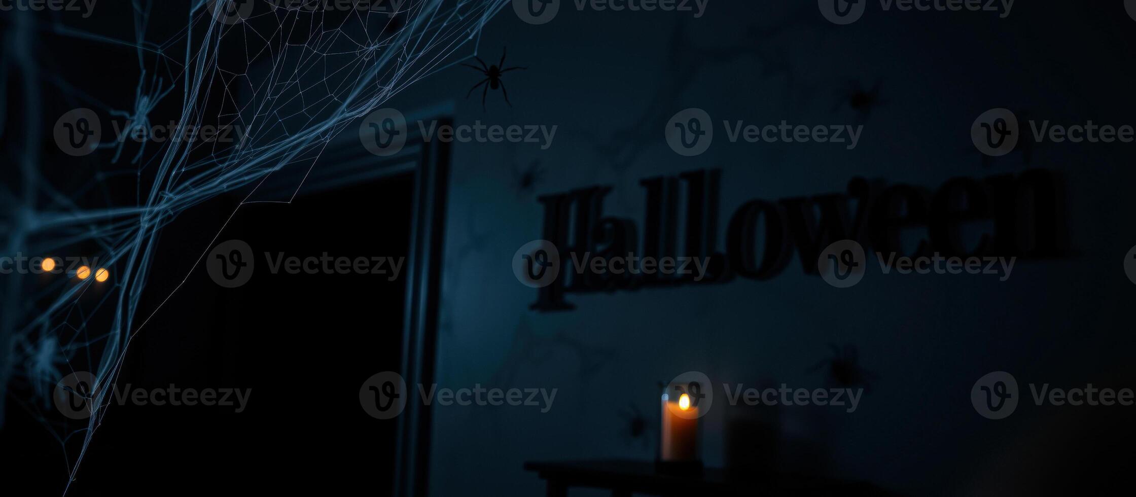 spider web with a single light source casts a faint glow on a halloween decoration. photo