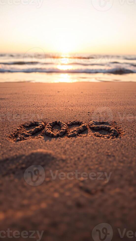 year 2022 written sand on a beach at sunset photo