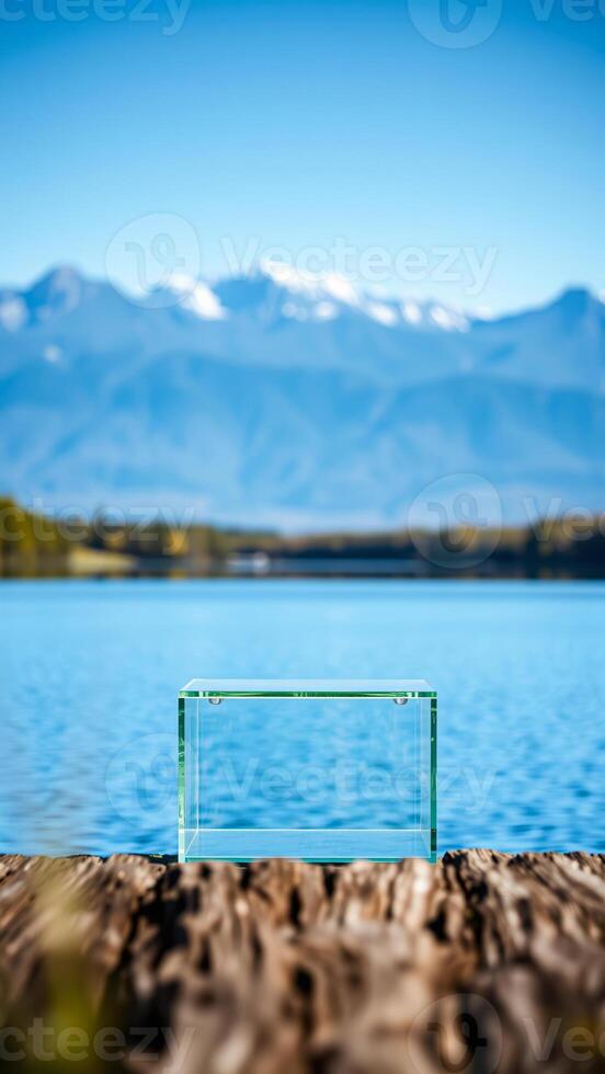 clear glass box resting on a wooden dock with a scenic water view photo