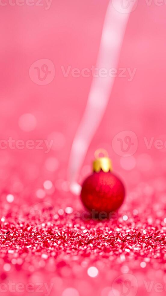 single red bauble on a glitter bed photo