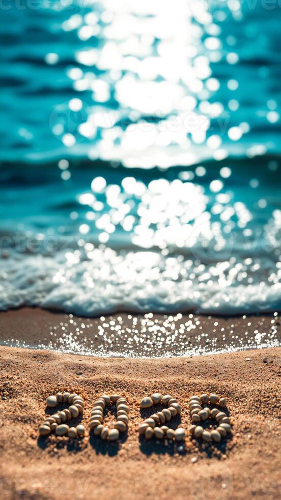 year 2022 crafted seashells on a sandy beach photo