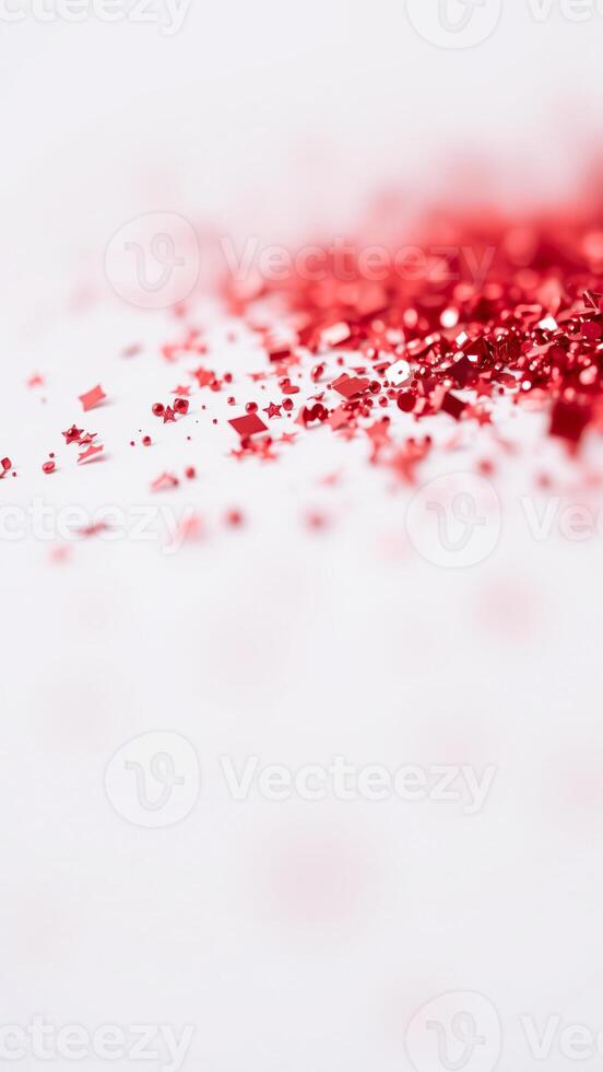 scattered red glitter stars squares on white surface photo