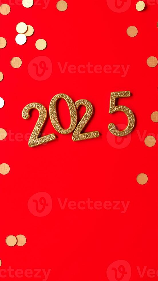 golden 2025 numbers on red background with confetti photo