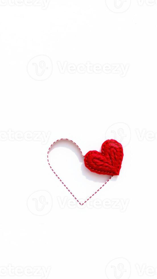 red felt heart on white background photo