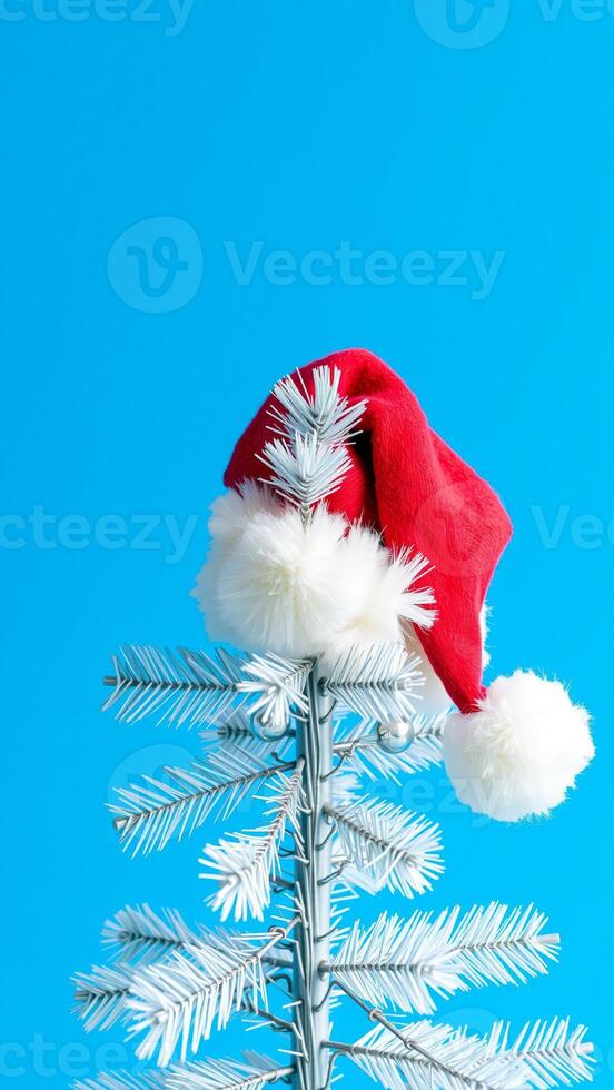 white artificial tree wearing a red hat photo
