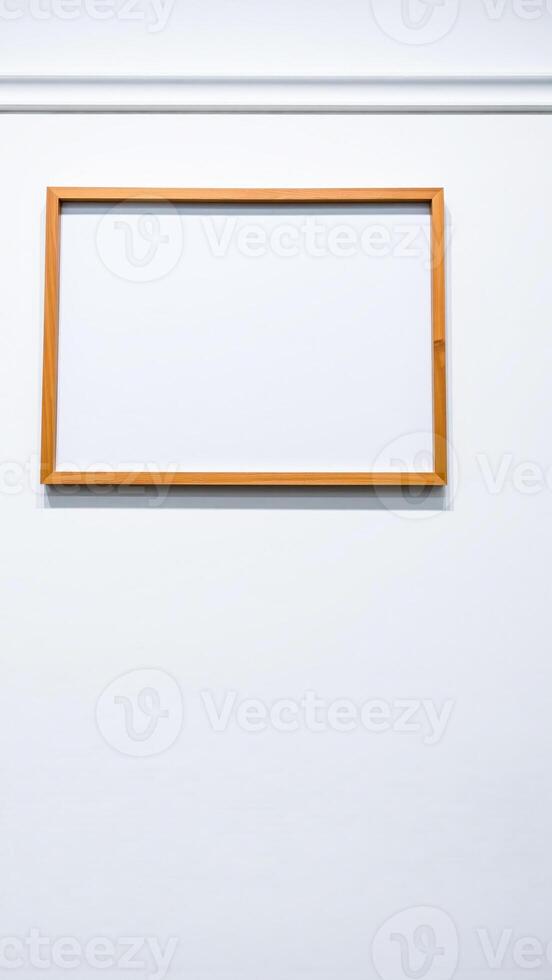 empty wooden frame on a white wall photo
