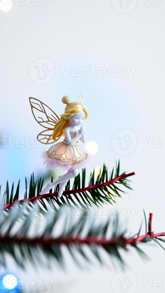 delicate porcelain fairy ornament on a pine branch photo