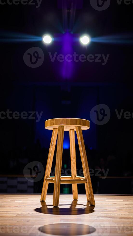 single wooden stool under spotlights photo