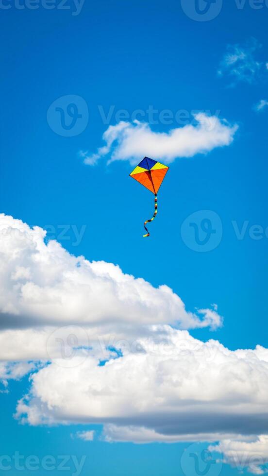 colorful kite soaring a clear blue sky photo