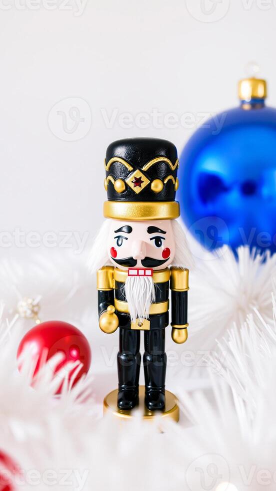 traditional nutcracker figurine with a blue christmas ornament photo