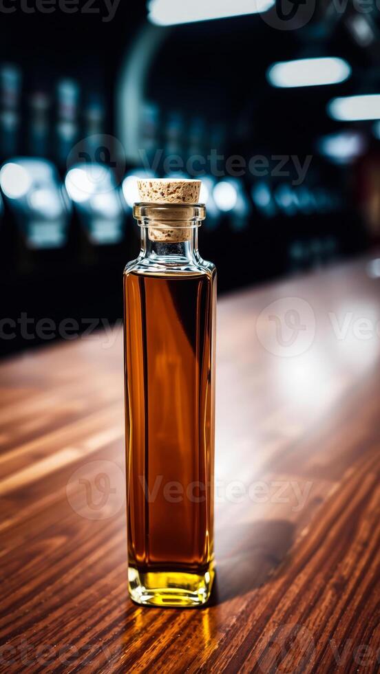 glass bottle golden liquid on a wooden surface photo