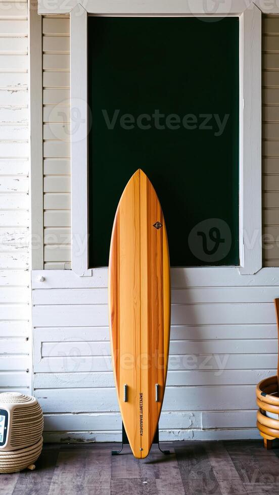 wooden surfboard leans against a white-paneled wall photo