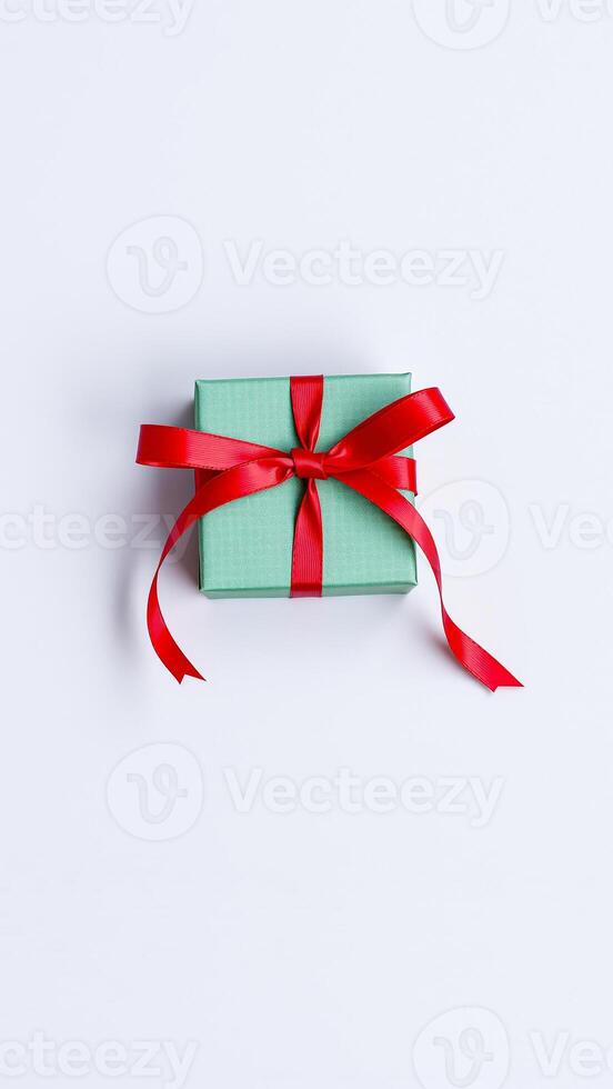 green gift box with a red ribbon photo