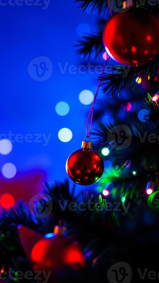 red ornament hangs on a christmas tree photo
