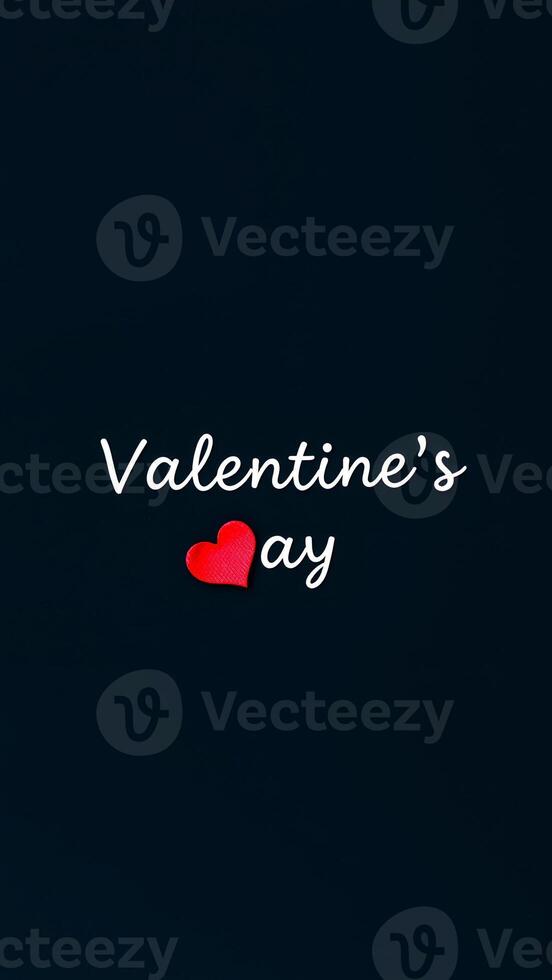 red heart on a dark background with valentine's day white script photo