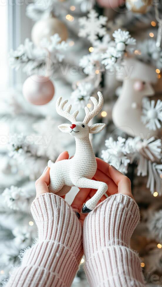 pair hands holding a white reindeer figurine photo