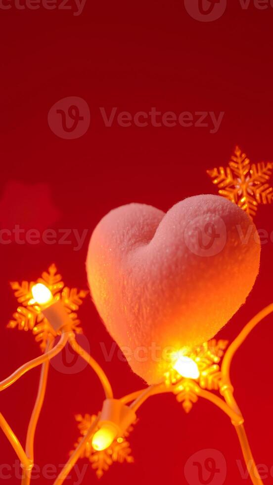 plush pink heart glows on a string snowflake lights photo