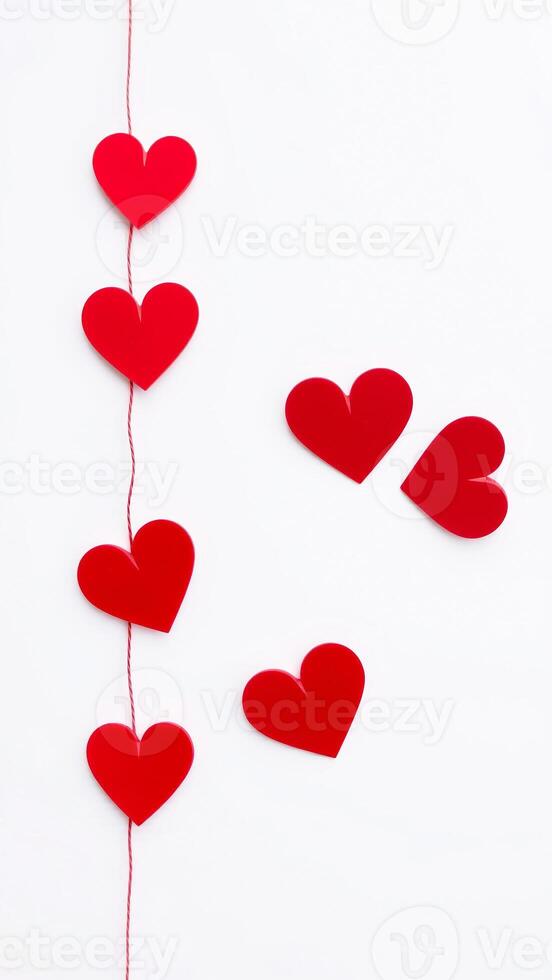 red paper hearts strung on twine photo