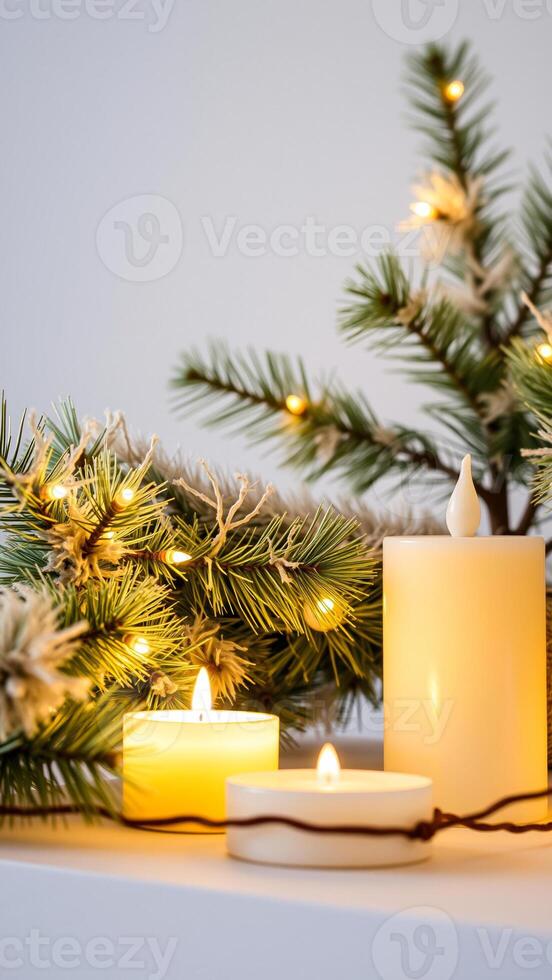 lit candles with pine branch string lights photo