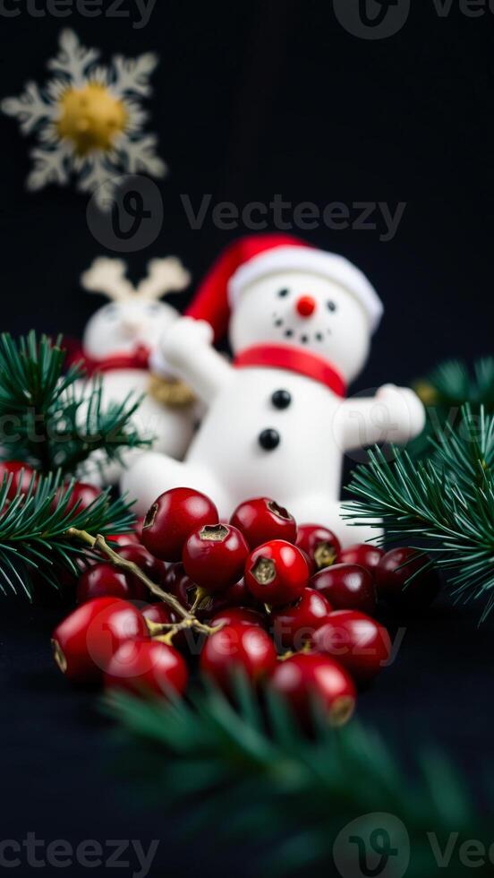 red berries green pine branches with white snowmen photo