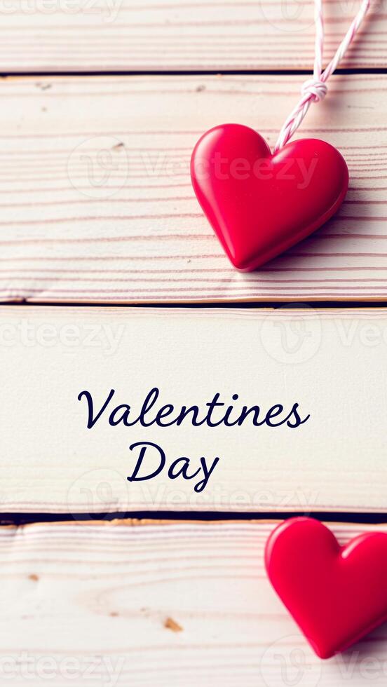 hanging heart on a white wood board with valentine's day written below photo