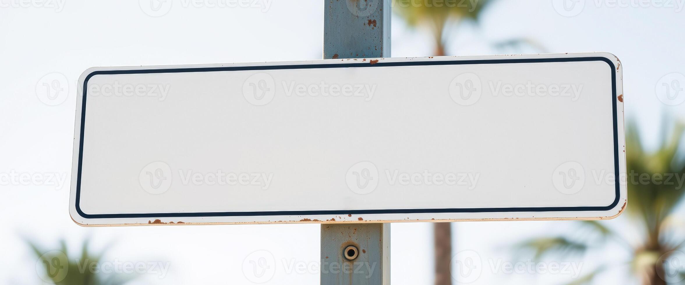 blank rectangular sign mounted on a rusted pole photo