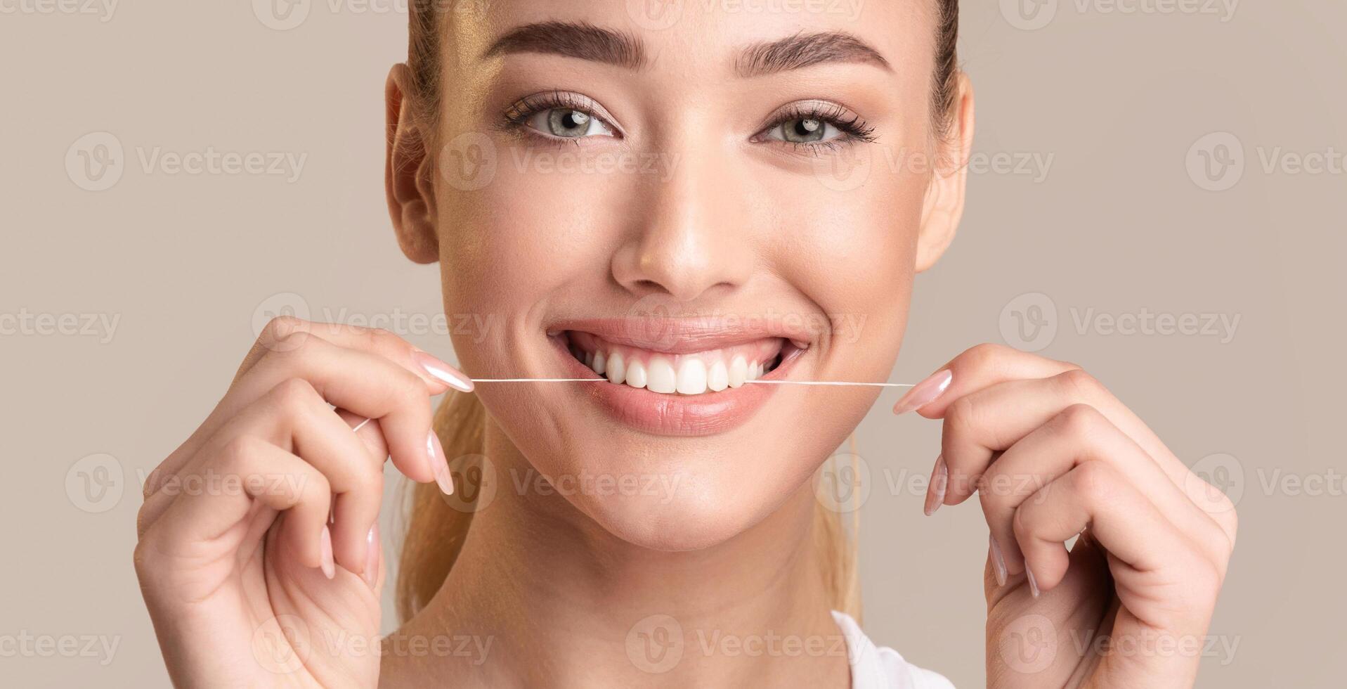 Teeth Flossing. Smiling Woman Using Tooth Floss Cleaning And Caring For Perfect White Teeth Posing Over Beige Background. Panorama photo