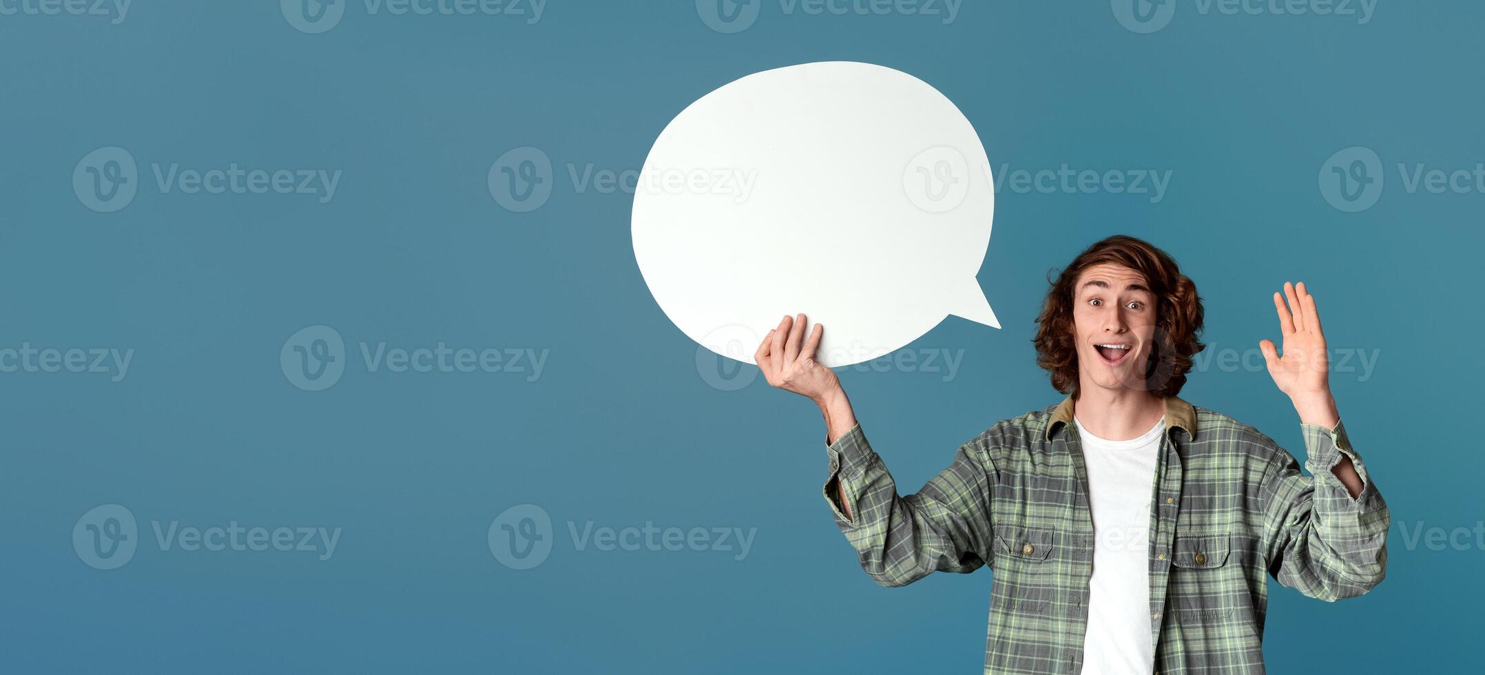 Cool guy holding speech bubble and waving on turquoise background, blank space photo