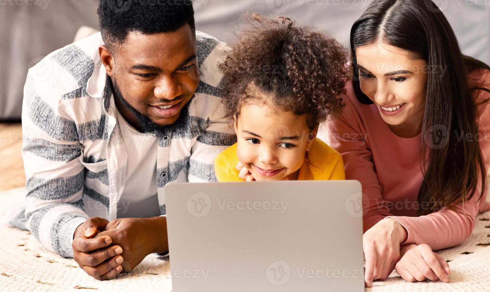 Multiracial family looking at laptop during covid-19 quarantine photo