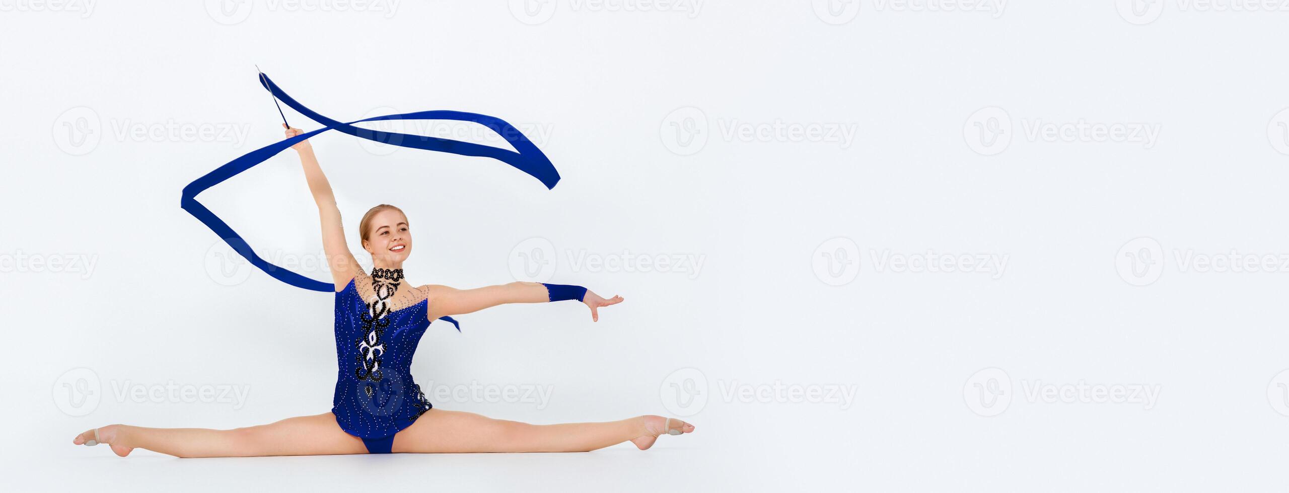 Beautiful professional gymnast with red ribbon doing leg split on white background, panorama photo