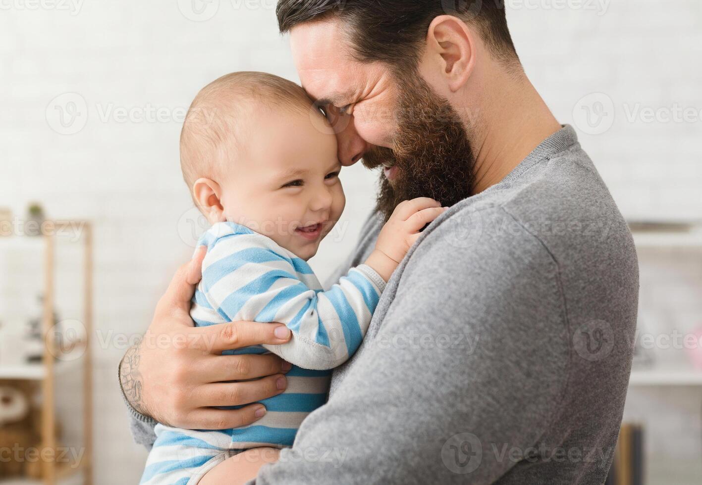 Cheerful father and son cuddling at home, enjoying time together photo
