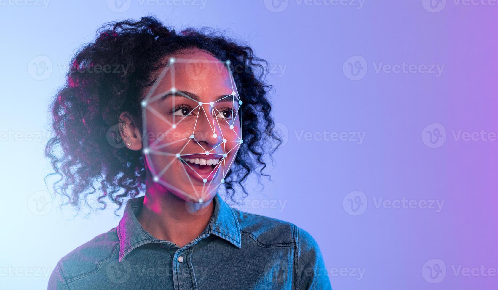 African American woman with curly hair is smiling as light patterns for facial recognition overlay her face. The vibrant background enhances the futuristic and engaging atmosphere of the moment. photo
