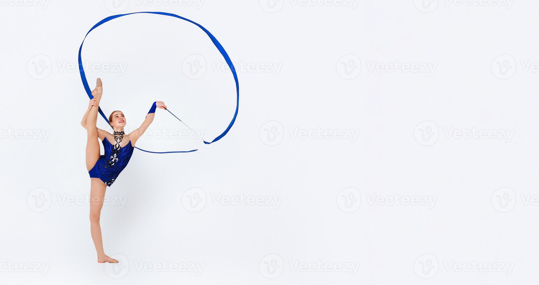 Attractive young gymnast with ribbon getting ready for professional competition, white background photo