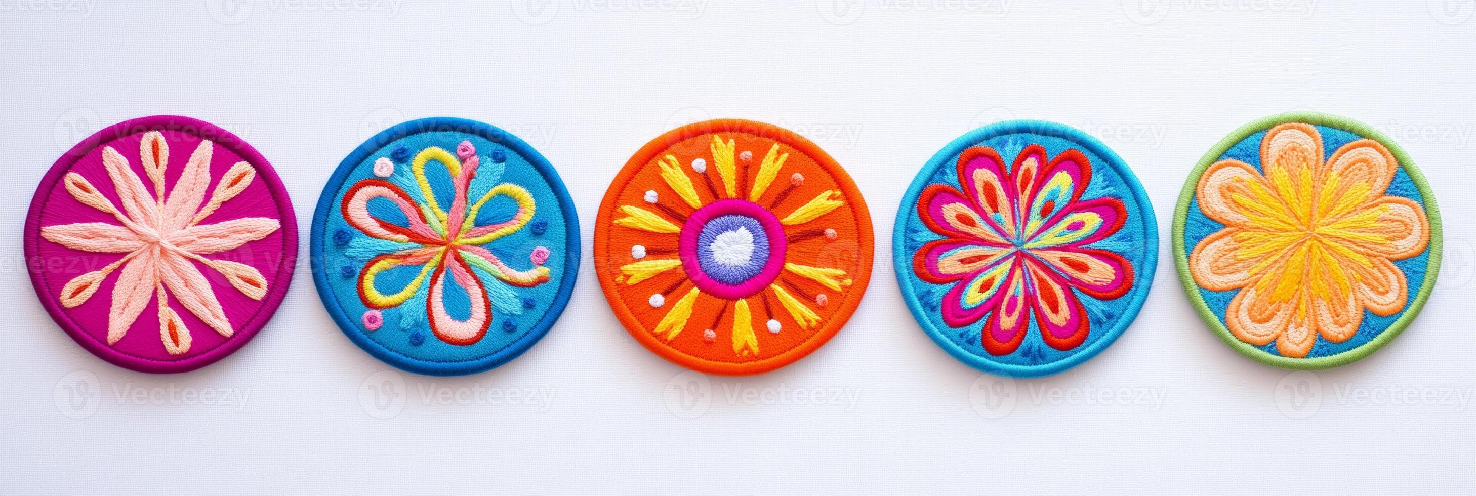A collection of five vibrant, abstract floral embroidered patches in various colorful designs photo