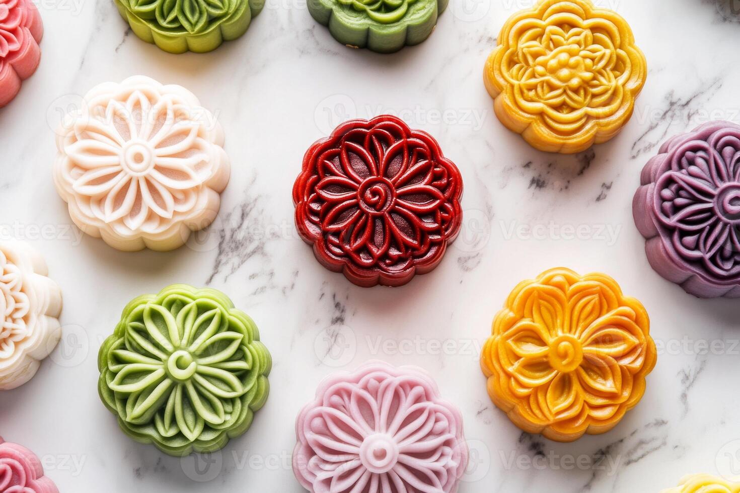 A collection of beautifully decorated mooncakes in vibrant colors and intricate floral designs on a marble surface photo