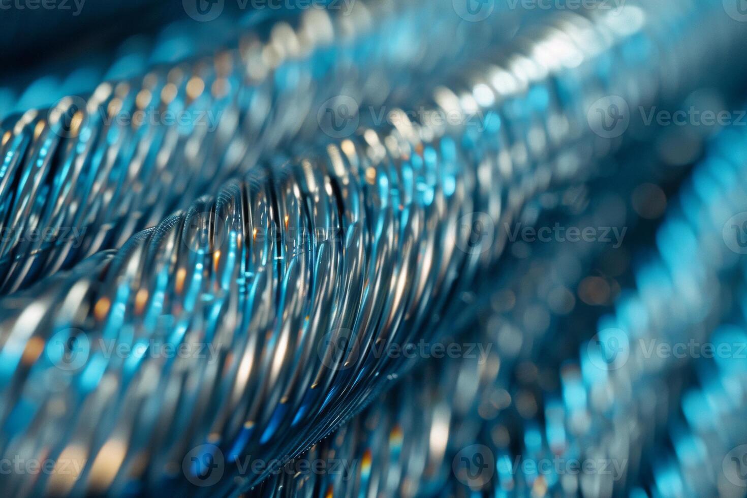 Close-up of smooth, coiled steel wire in cool metallic tones, reflecting soft light photo