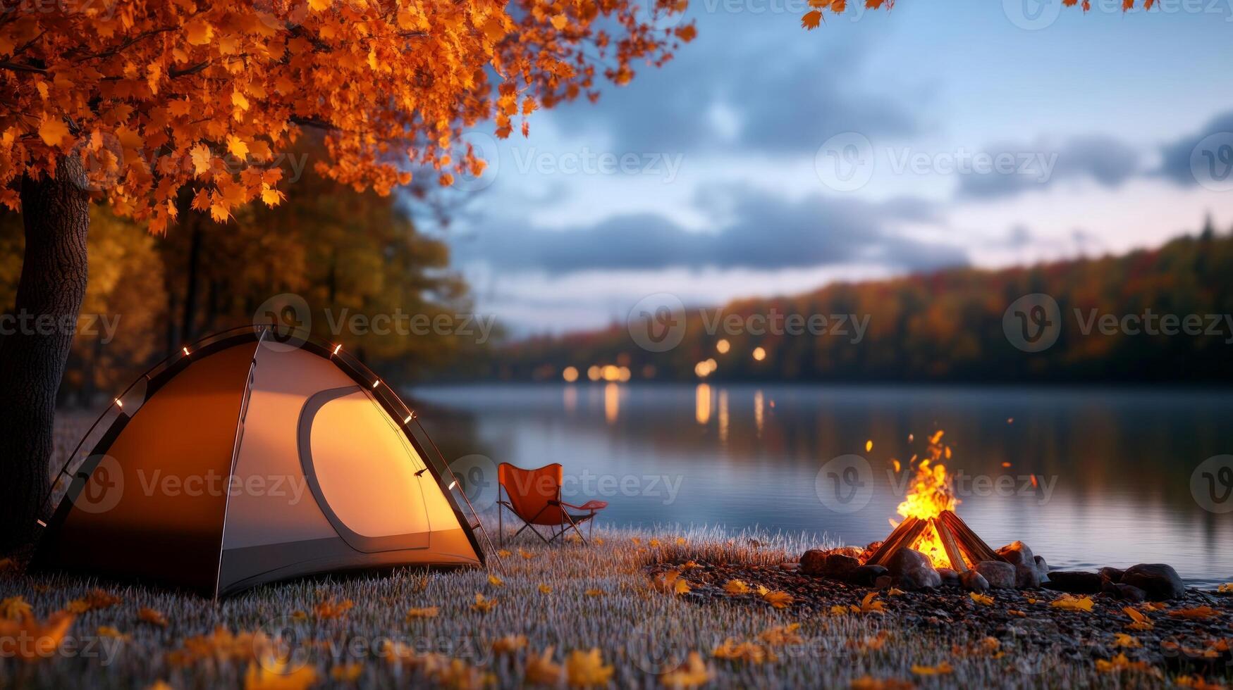 Scenic autumn camping by a tranquil lake with a glowing campfire, a tent, and vibrant orange foliage photo