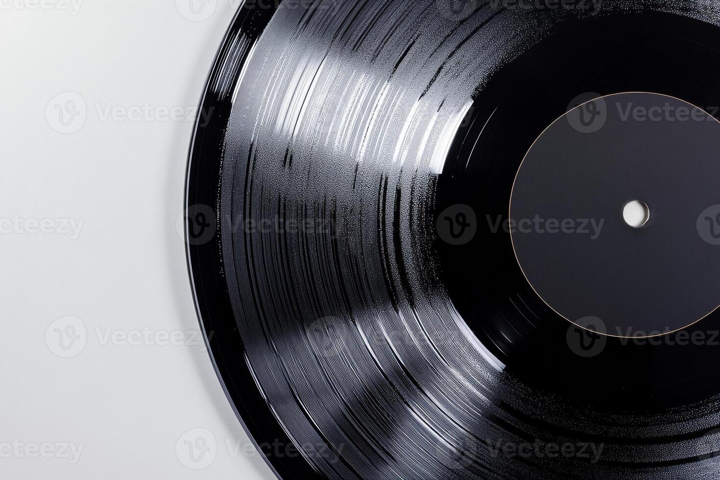 A close-up of a vinyl record with a blank black label on a white background, showcasing its grooves and glossy finish photo