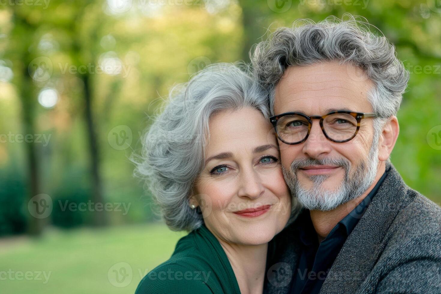 A happy couple enjoying a warm embrace in a serene park during a sunny afternoon photo