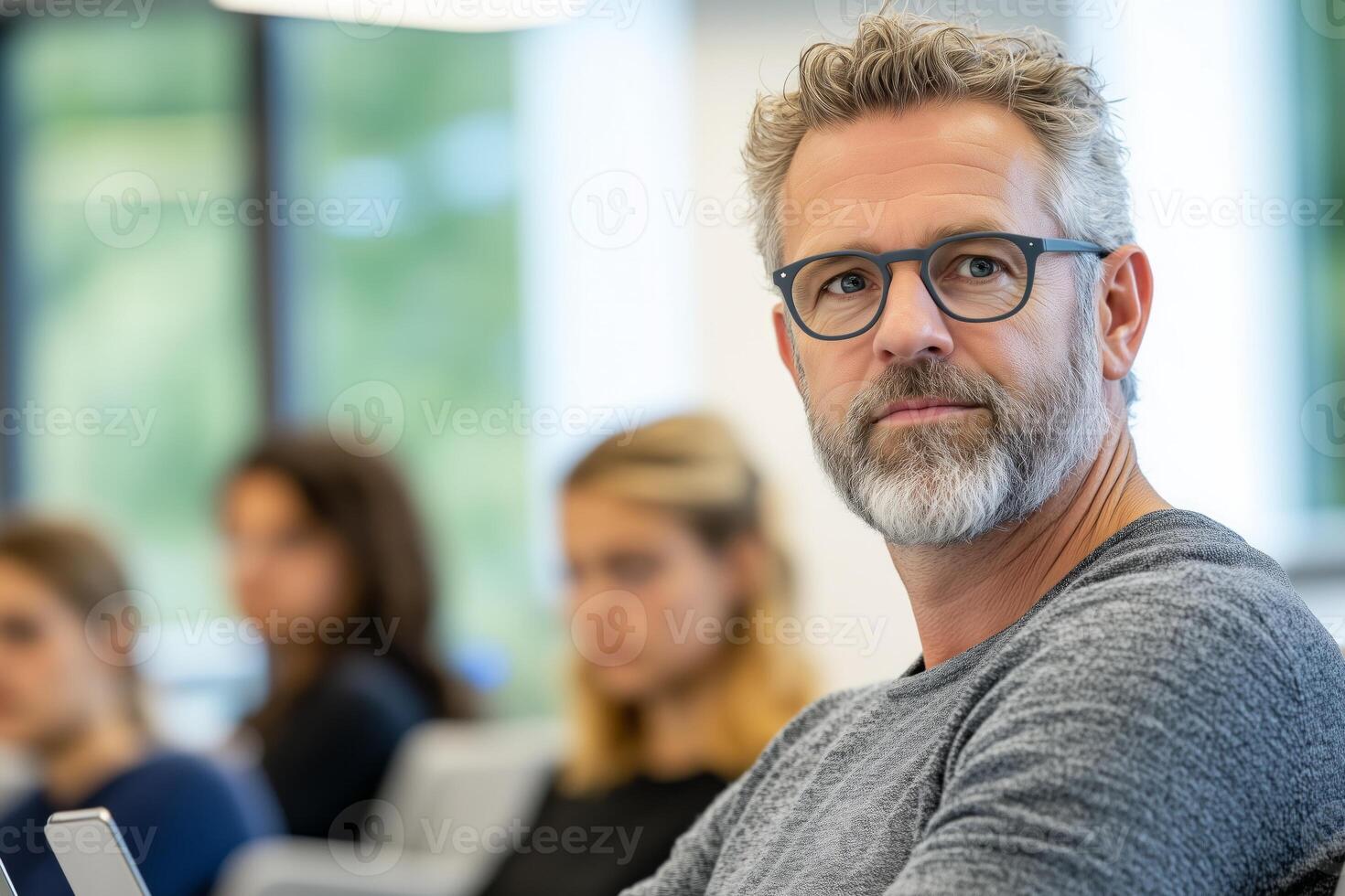 Professor explaining concepts to attentive students in a bright lecture hall setting photo