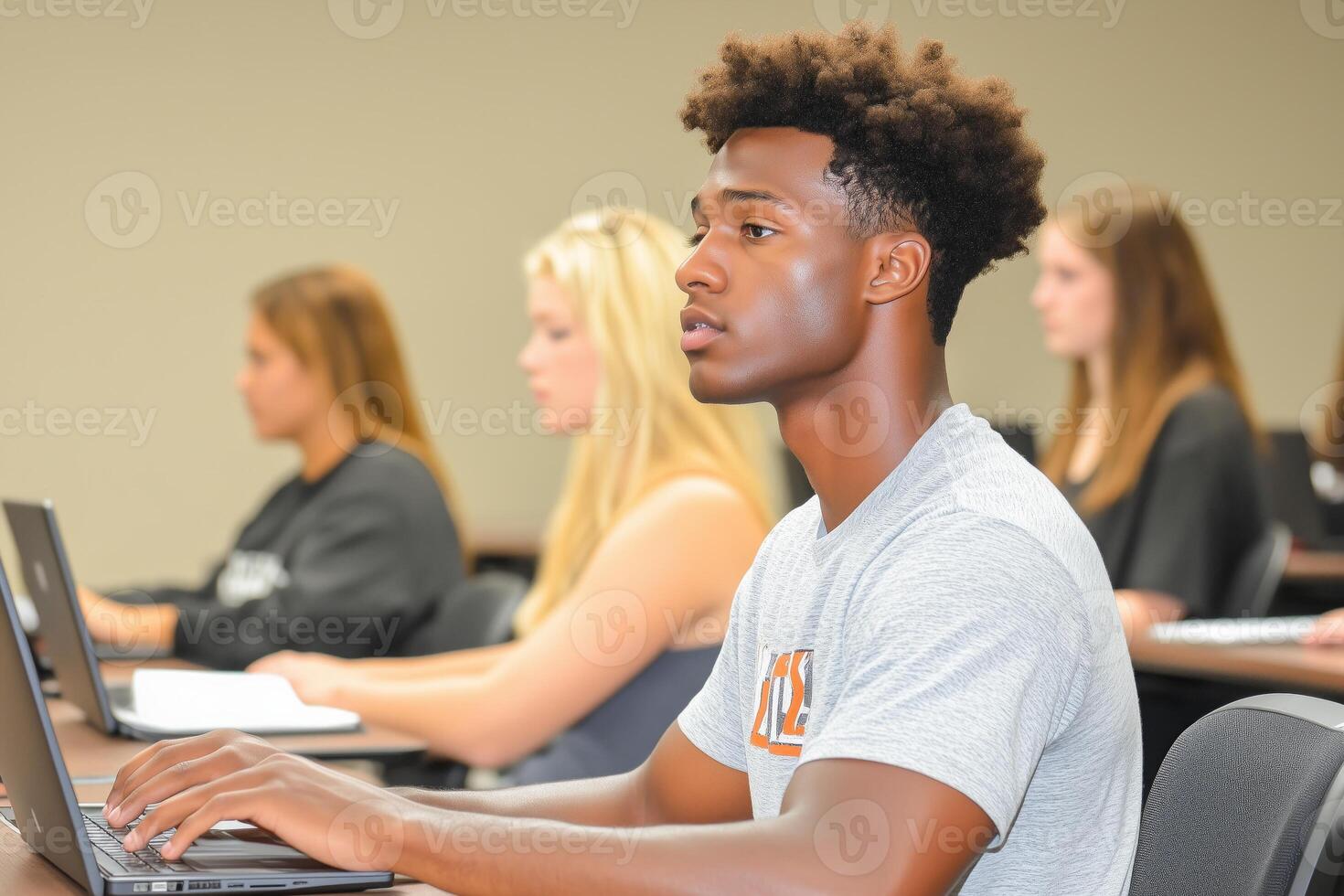 Students engaging with laptops in a minimalistic classroom during a lecture session photo