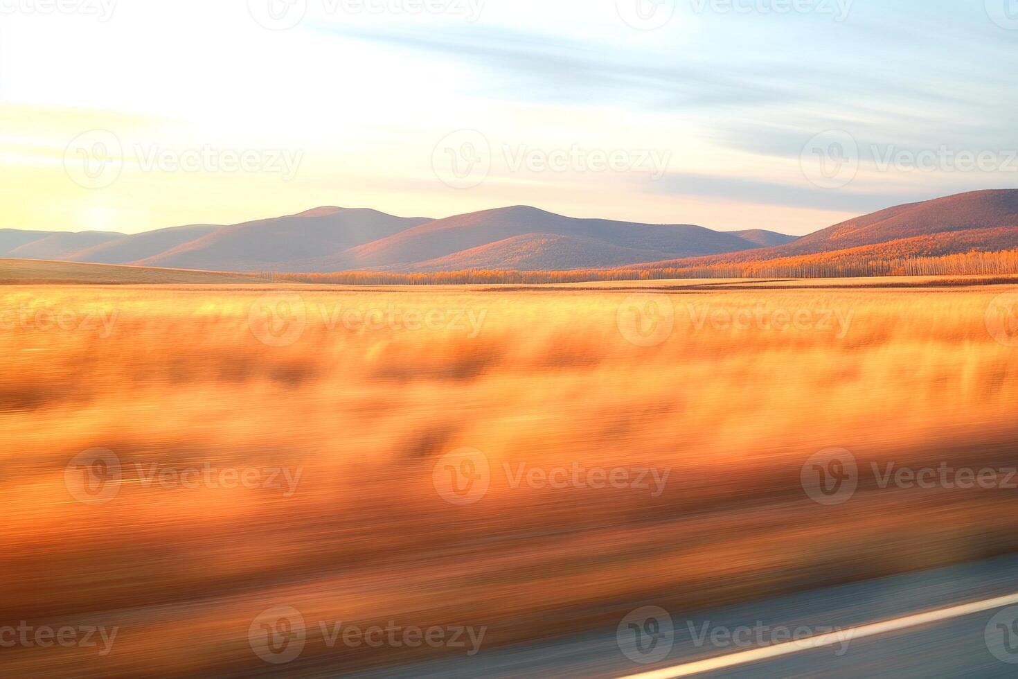 Golden sunset view from a car window with autumn landscape and serene hills in the distance photo