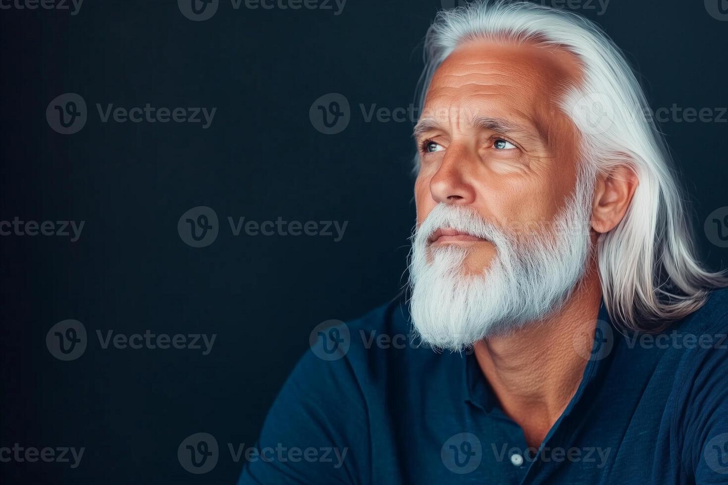 Elderly man with long white hair gazes thoughtfully into the distance, showcasing wisdom and contemplation photo